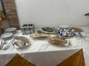 a table topped with plates and bowls of food at Hotel Fernanda in Letojanni