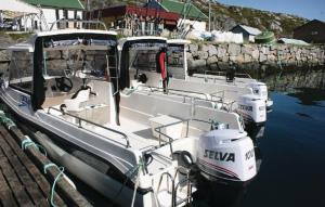two boats are docked in the water at a dock at 2 Bedroom Awesome Apartment In Kårhamn in Vatna