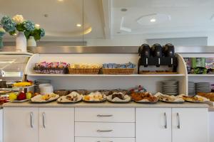 a kitchen with plates of food on a counter at Hotel Bristol in Caorle