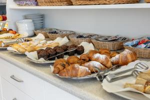 a table with many different types of bread and pastries at Hotel Bristol in Caorle