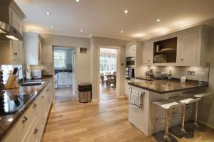 a kitchen with white cabinets and a large counter top at Exquisite location close to the sea! in Frinton-on-Sea