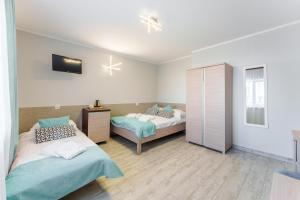 Łóżko lub łóżka w pokoju w obiekcie Villa Rafałko