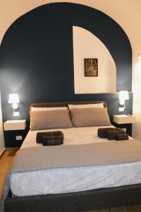 a bedroom with a large bed with two pillows at Casa fortino in Catania +35 photos