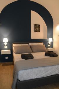 a bedroom with a large bed with two lamps at Casa fortino in Catania