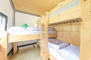 a bunk bed room with two bunk beds in it at Camping Heino in Heino