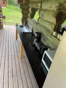 a kitchen counter with a sink in a log cabin at Tammeoja puhkemaja in Sõmeru