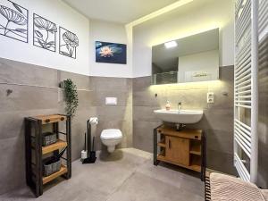 a bathroom with a sink and a toilet at Landidyll Elmenhorst Wohnung 02 in Elmenhorst +58 photos