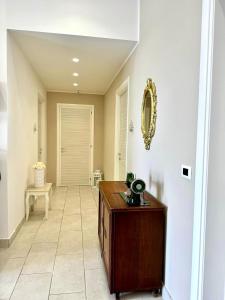 a hallway with a table and a mirror on a wall at B&B Casa Dolce Casa in Nardò +68 photos