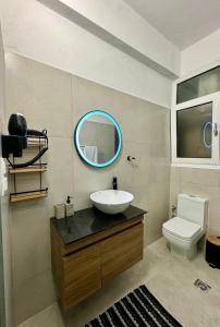 a bathroom with a sink and a toilet and a mirror at Molys House in Igoumenitsa +18 photos