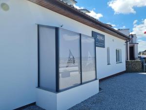 a building with windows with a view of the ocean at Rewa Morska 103 in Rewa