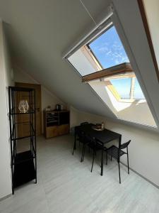 a dining room with a table and a window at Rewa Morska 103 in Rewa
