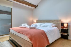 a bedroom with a large bed with towels on it at CHATEAU LAURIGA in Thuir +24 photos