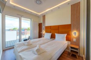 Posteľ alebo postele v izbe v ubytovaní Oaza Spa z prywatną Sauną by Perłowa Przystań Rent