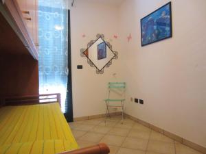 a bedroom with a mirror on the wall and a chair at Leuca Villetta Vista Mare in Leuca