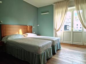 Postel nebo postele na pokoji v ubytování B&B Residenza Cavour