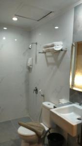 a bathroom with a toilet and a sink at Laxston Hotel in Yogyakarta