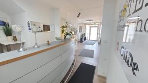 a hallway of a store with a counter with plants at Hotel Schneiderhof in Braunlage
