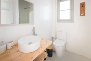 a white bathroom with a sink and a toilet at Swell S11 new studio in Naousa in Naousa