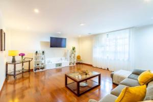 a living room with a couch and a table at Ciudad Jardín Las Palmas GC in Las Palmas de Gran Canaria