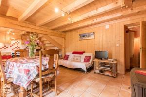 a bedroom with a bed and a tv in a room at Le Balcon de Novel - Chalet en pleine nature in Novel