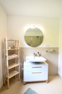 a bathroom with a white sink and a mirror at Ferienhaus JOLOISIA mit Blick auf Planai in Schladming