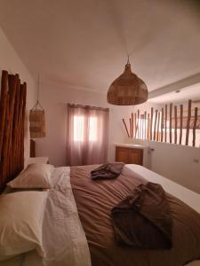 a bedroom with a large bed in a room at La Maison des Vagues in Sidi Kaouki +37 photos