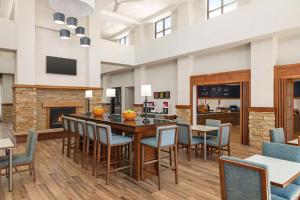 斯普林菲尔德Hampton Inn & Suites Springfield的一间有桌椅和壁炉的餐厅