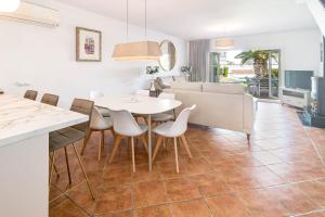 a kitchen and dining room with a white table and chairs at PG9 - Andalucian 3-story townhouse near Estepona in Estepona