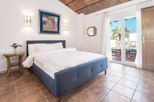a bedroom with a large bed and a balcony at PG9 - Andalucian 3-story townhouse near Estepona in Estepona +54 photos