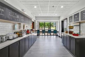 a kitchen with a long line of counters in a restaurant at Hampton Inn Houston-Pearland, TX in Pearland