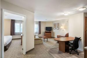 a hotel room with a bed and a desk and a room at Suburban Studios Waterloo in Waterloo