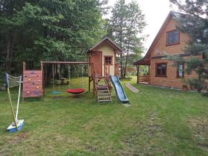 a playground with a slide and a house at Agroturystyka Uroki Roztocza in Zamość
