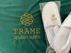 a green shirt with the words frameanuillian suites on it at Trame - Poesia Di Mare in Polignano a Mare