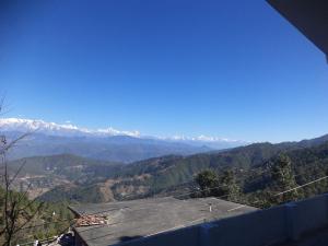 a view of a mountain range with snow capped mountains at Snow View Guest House Kausani & homestay in Kausani