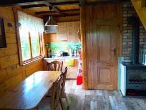 a kitchen with a wooden table and a stove at Nad żabim stawem in Jałowo