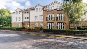 an empty street in front of a brick building at STN - Bishops's Stortford - Free Gated Parking - Two Bed Apartment - Perfect location for Stansted Airport in Bishops Stortford
