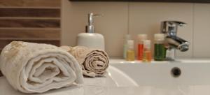 a roll of towels sitting on a bathroom sink at Luxury Villa konstantina! in Yerakiní +18 photos