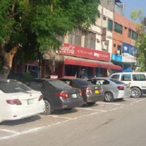 a group of cars parked on the side of a street at Hotel AL-Habib Islamabad in Islamabad