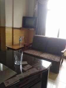 a living room with a couch and a table at Hotel AL-Habib Islamabad in Islamabad