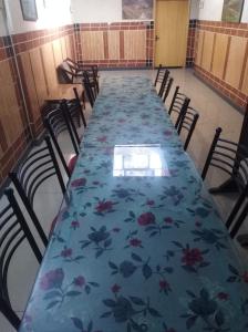 a long table with a blue cloth with flowers on it at Hotel AL-Habib Islamabad in Islamabad