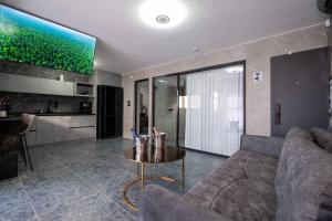 a living room with a couch and a table at מבנים בים 75-26 Suites at sea in Haifa