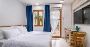 a bedroom with a bed and a table and a window at Oleander Trogir Suites in Trogir