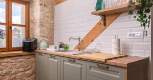 a kitchen with a sink and a counter top at Oleander Trogir Suites in Trogir +16 photos