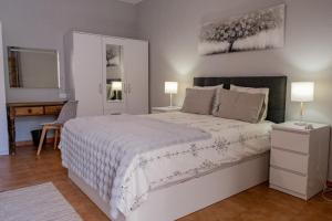 Ένα ή περισσότερα κρεβάτια σε δωμάτιο στο São Vicente Guest House