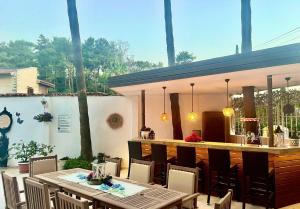 a patio with a bar and a table and chairs at Carikci Hotel in Marmaris