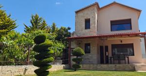 a house with a cactus in front of it at Luxury Villa konstantina! in Yerakiní