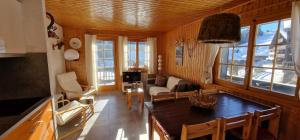 a kitchen and living room with a table and chairs at Myrtille 11 in Champoussin
