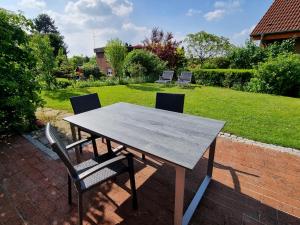 a table and chairs sitting on a brick patio at DortBlick Appartement in Dortmund