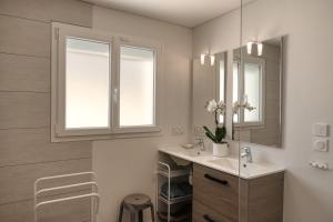 a bathroom with a sink and a mirror at Villa Quatreal Piscine privée, chauffée in Montségur-sur-Lauzon +27 photos