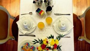 a table with two plates and two glasses of orange juice at Casa Pisani Canal in Venice